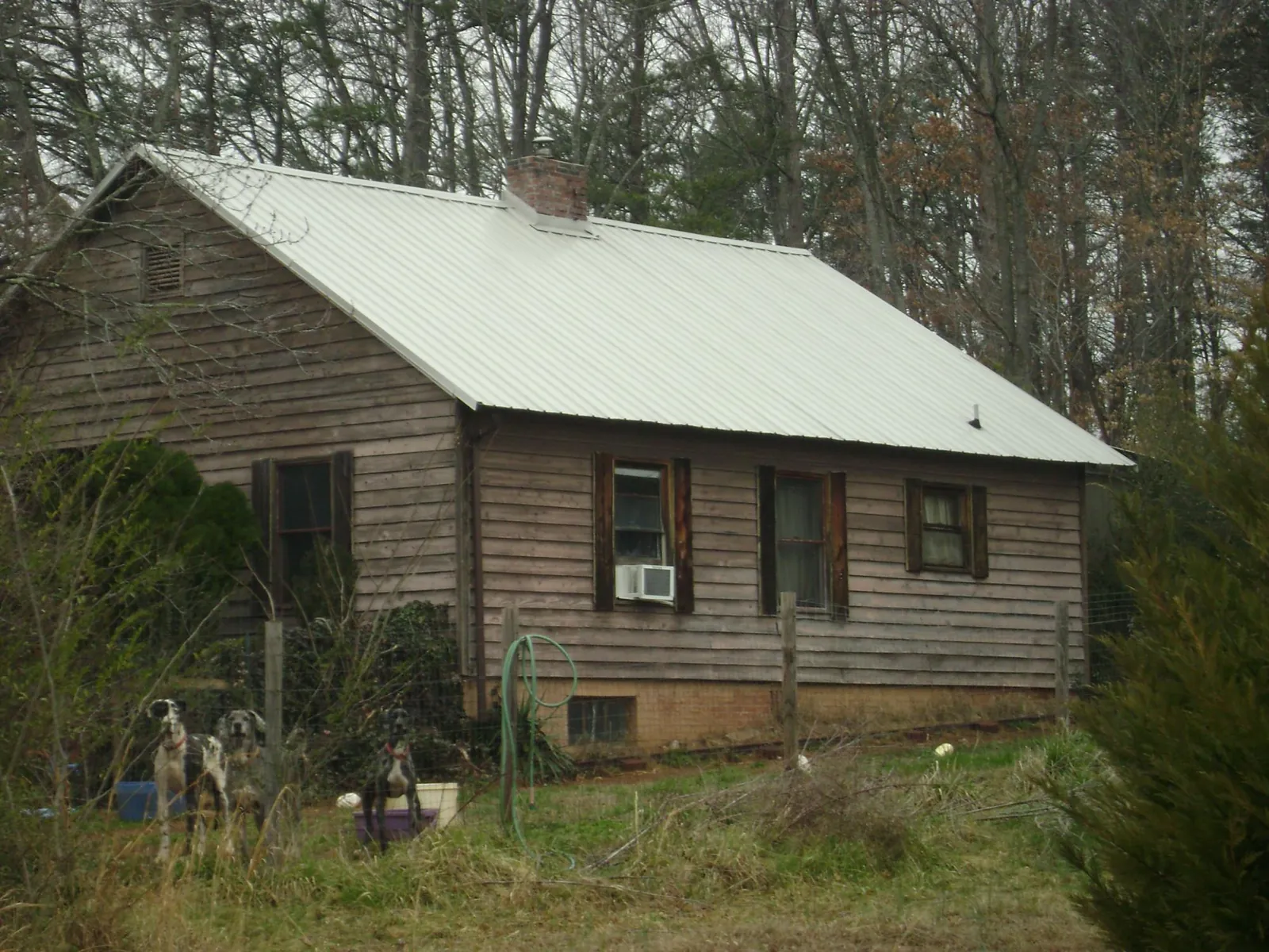 White metal roof on an old wood sided farmhouse, from a Metal Roof Installation job in Keystone Heights